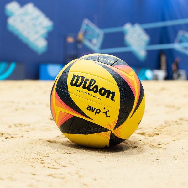 A Wilson AVP beach volleyball resting on sand.